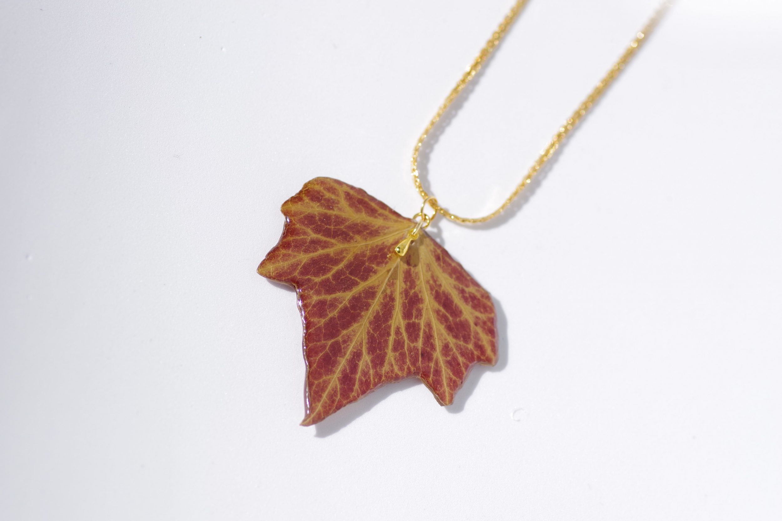 belle feuille de lierre aux couleurs d'automne transformée en pendentif sur une chaine plaquée or ouvragée