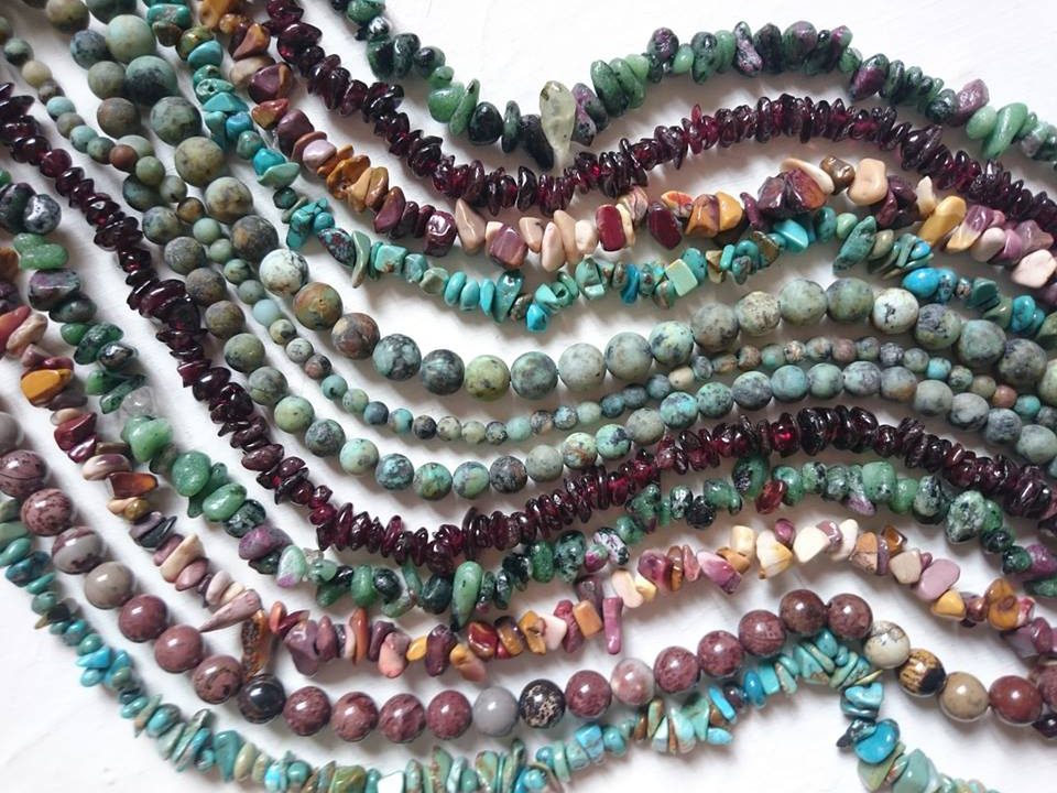 fils de perles de pierres, dans de tons turquoise, brique, vert et prune