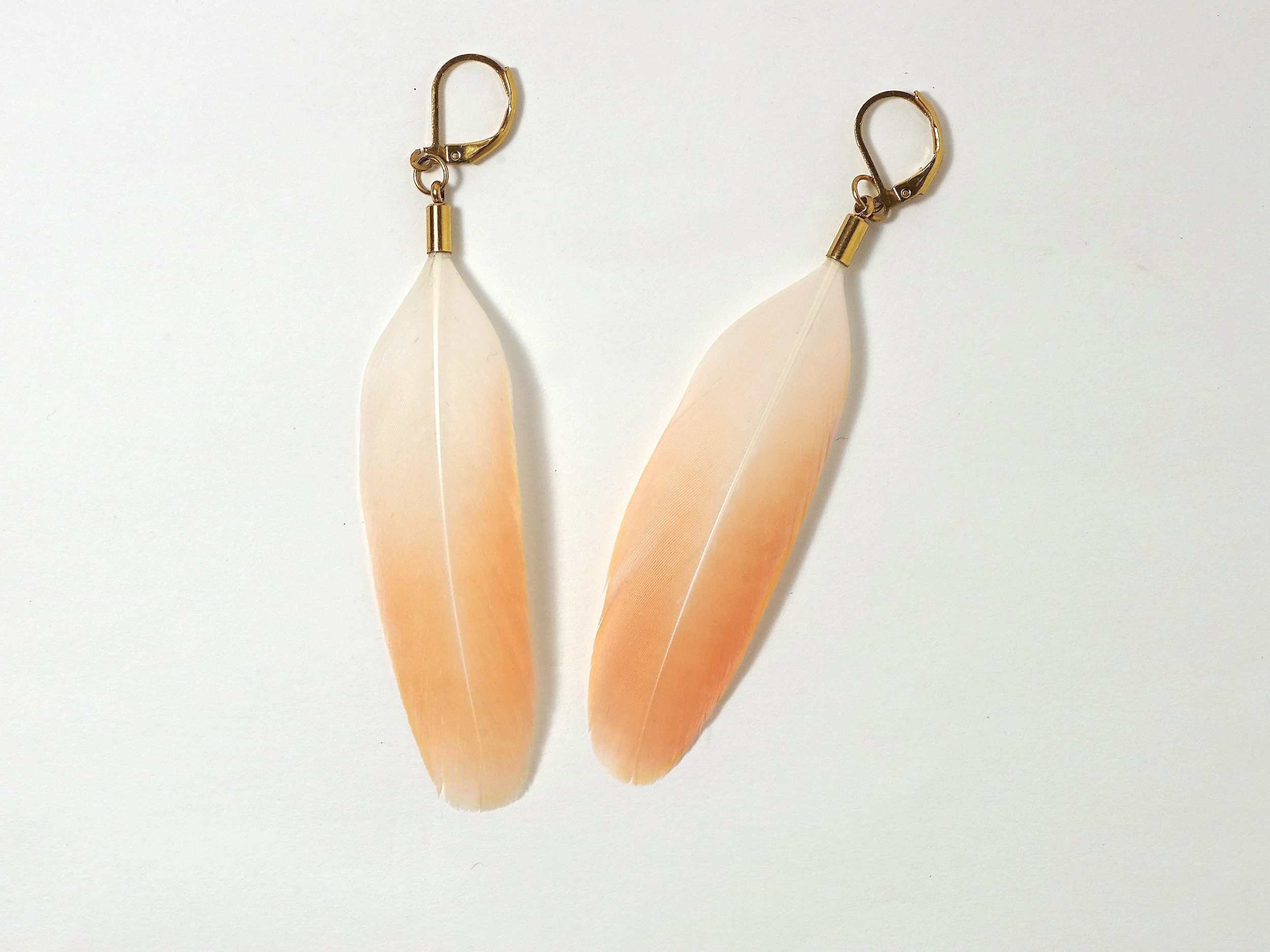 Boucles d'oreilles avec une plume de flamant orange, montage en inox doré.